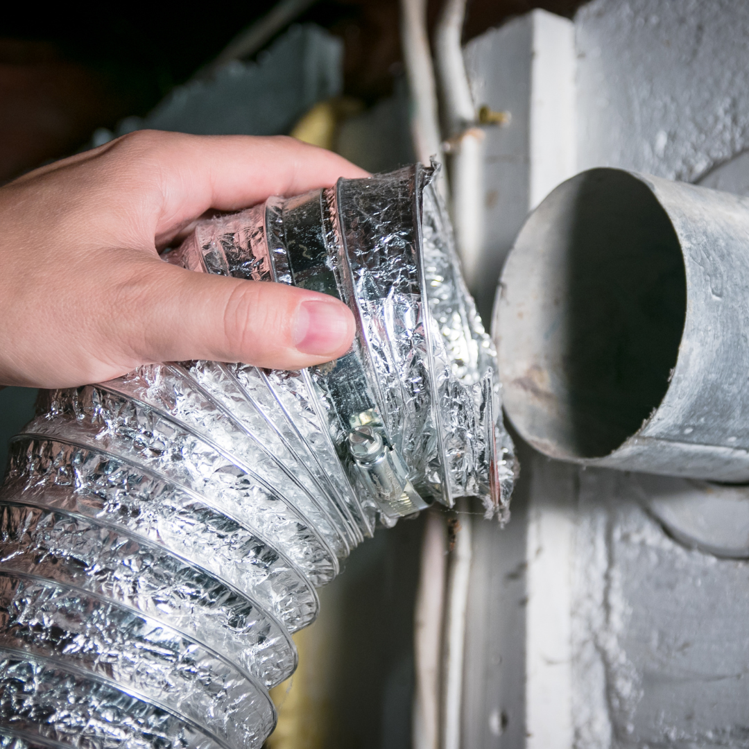 A professional cleaning an air duct in NY